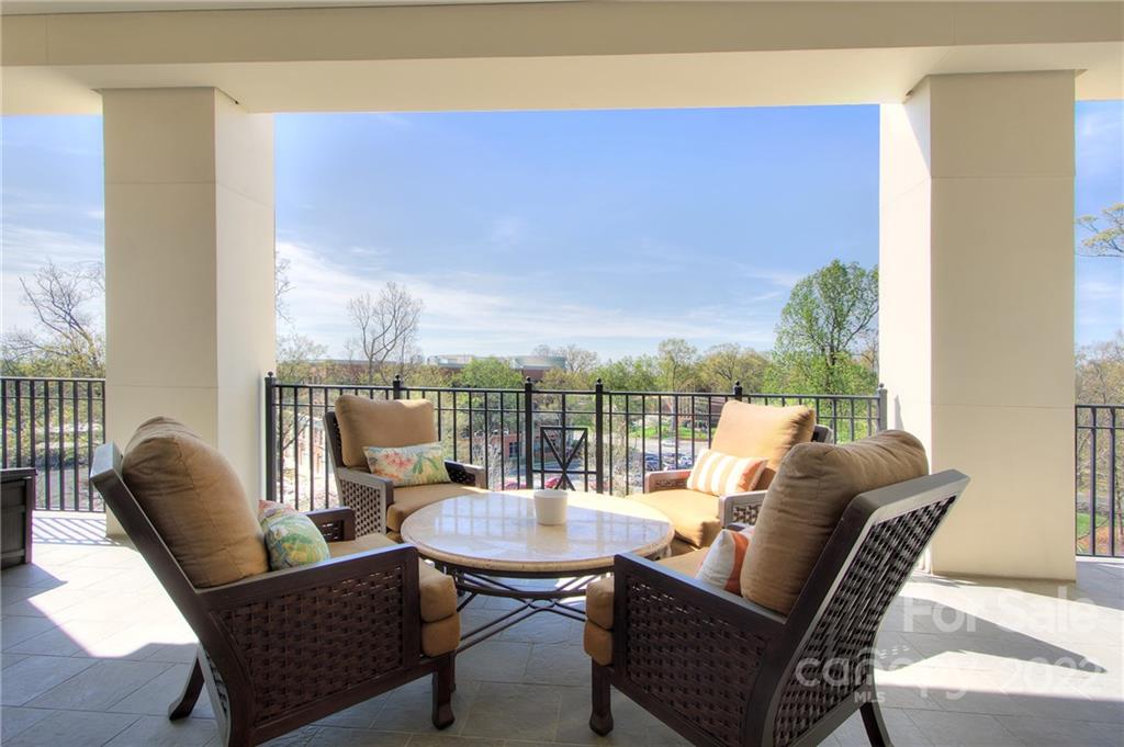 2823 Providence Road, Unit 254 Charlotte, NC 28211 - Photo 25 of 44 a balcony with furniture and wooden floor