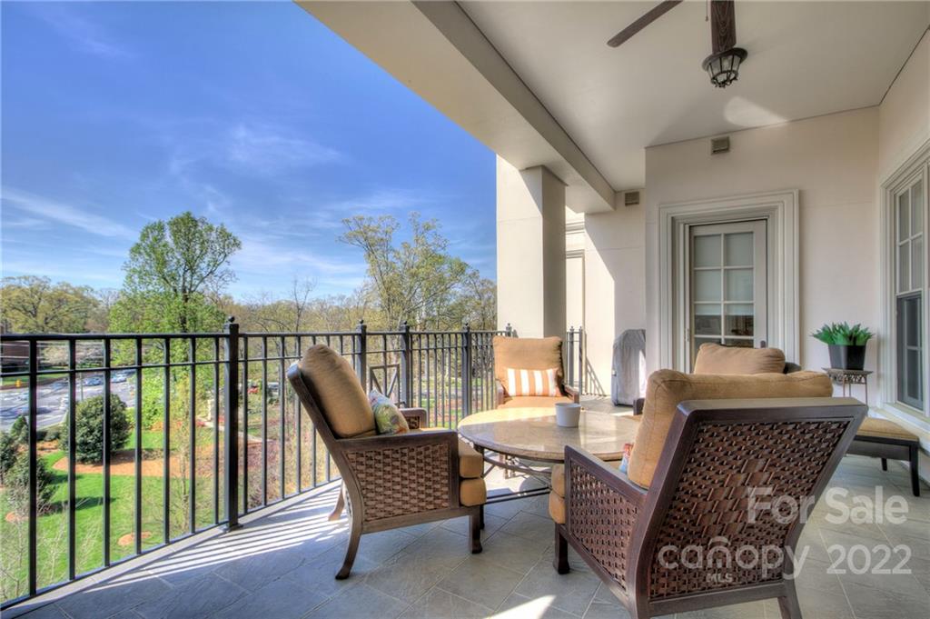 2823 Providence Road, Unit 254 Charlotte, NC 28211 - Photo 26 of 44 a living room with furniture and a floor to ceiling window
