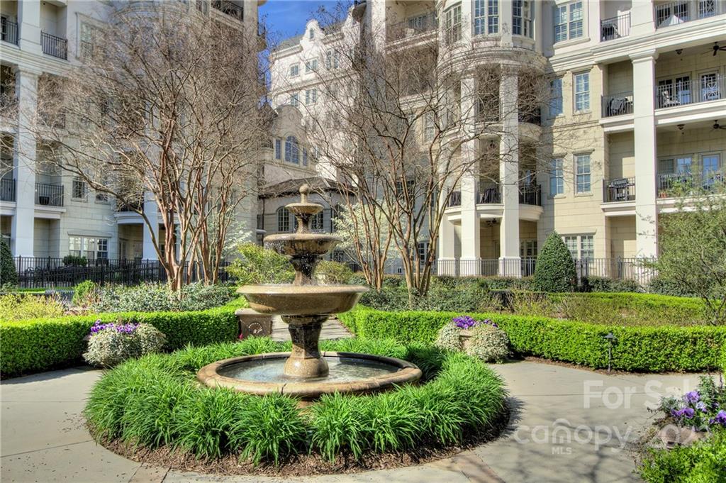 2823 Providence Road, Unit 254 Charlotte, NC 28211 - Photo 31 of 44 a front view of a residential apartment building with a yard and potted plants