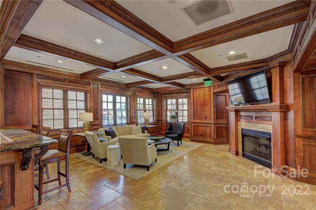 2823 Providence Road, Unit 254 Charlotte, NC 28211 - Photo 36 of 44 a living room with furniture a fireplace and a flat screen tv
