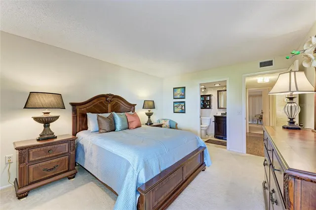 a bathroom with a sink a toilet a mirror a vanity and shower