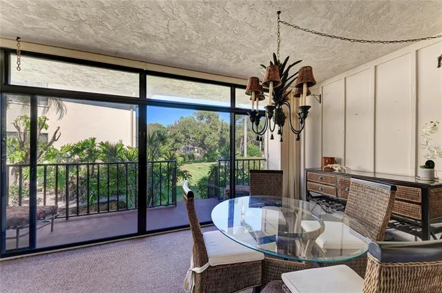 an aerial view of a house with a yard and greenery