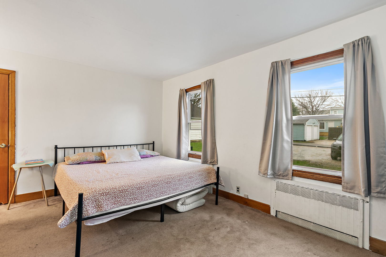 820 Lincoln Highway Rochelle, IL 61068 - Photo 20 of 27 a bed sitting in a bedroom next to a window