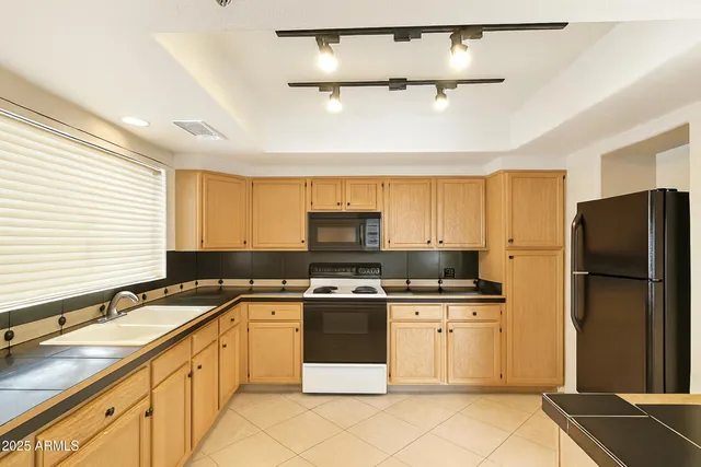 a kitchen with a sink stove and refrigerator
