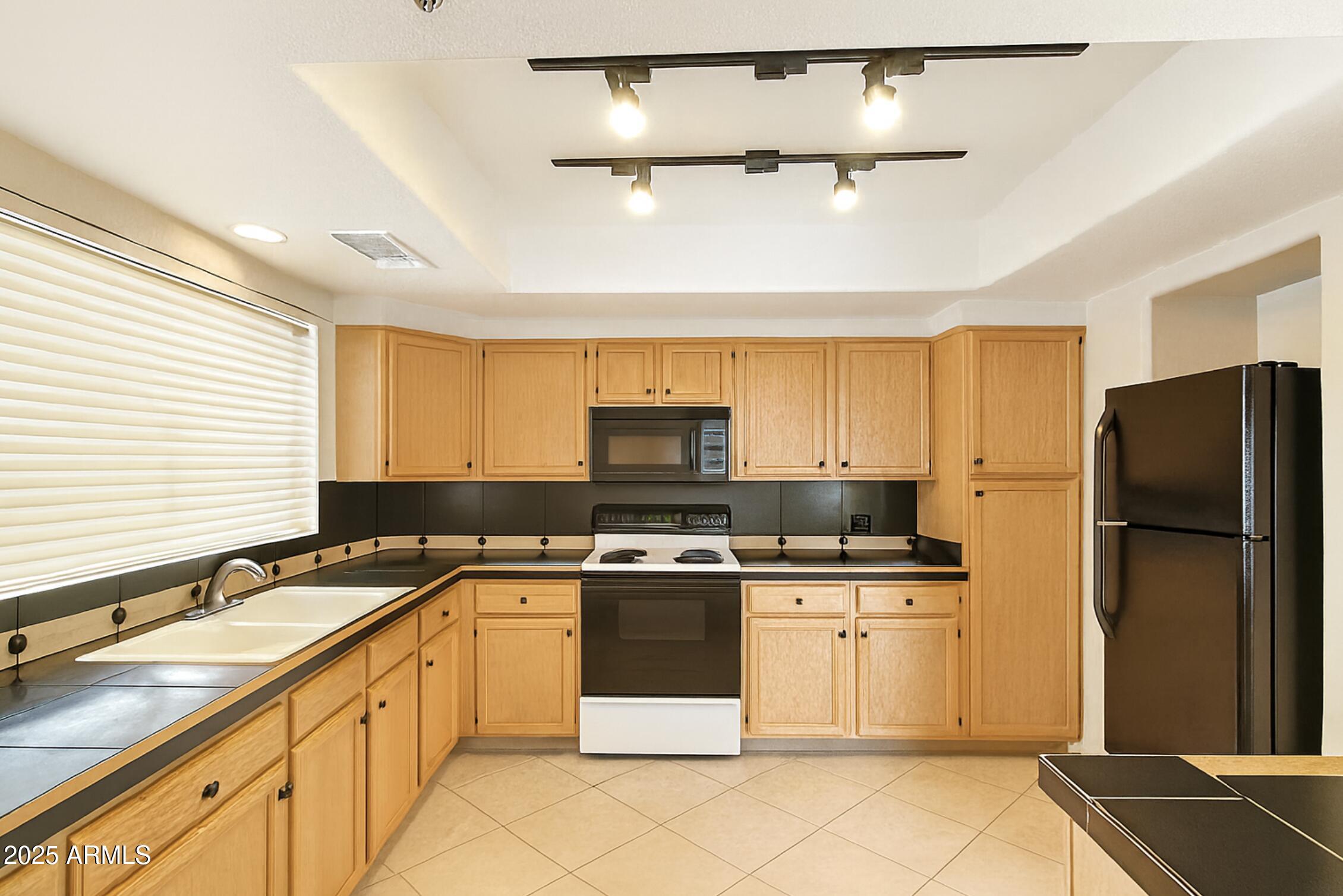 a kitchen with a sink stove and refrigerator