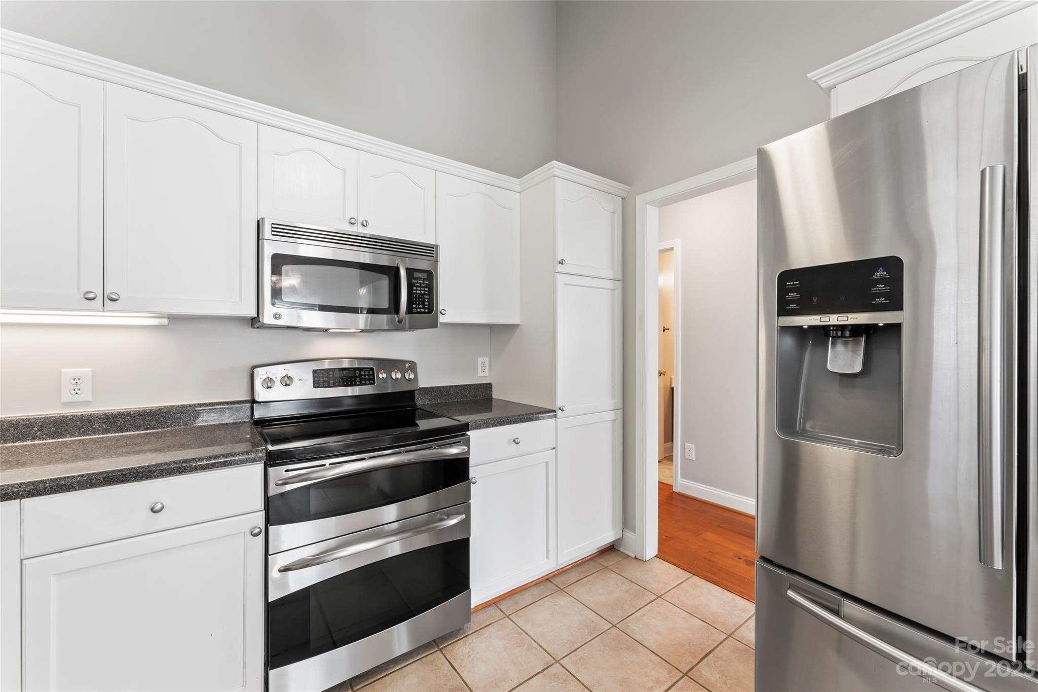 3205 McGee Lane Monroe, NC 28110 - Photo 13 of 34 a kitchen with a refrigerator stove and microwave