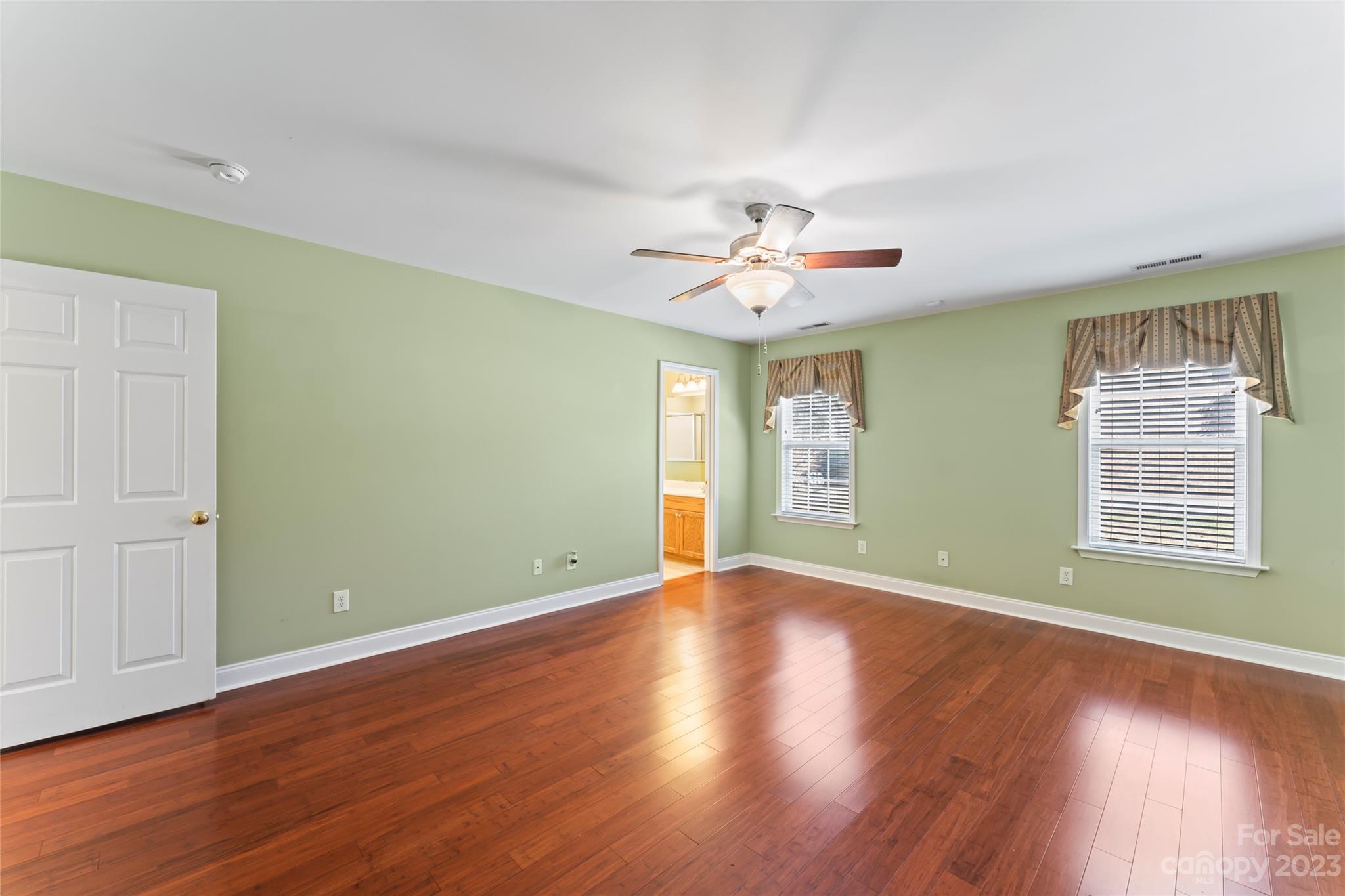 3205 McGee Lane Monroe, NC 28110 - Photo 16 of 34 a view of an empty room with wooden floor and a window