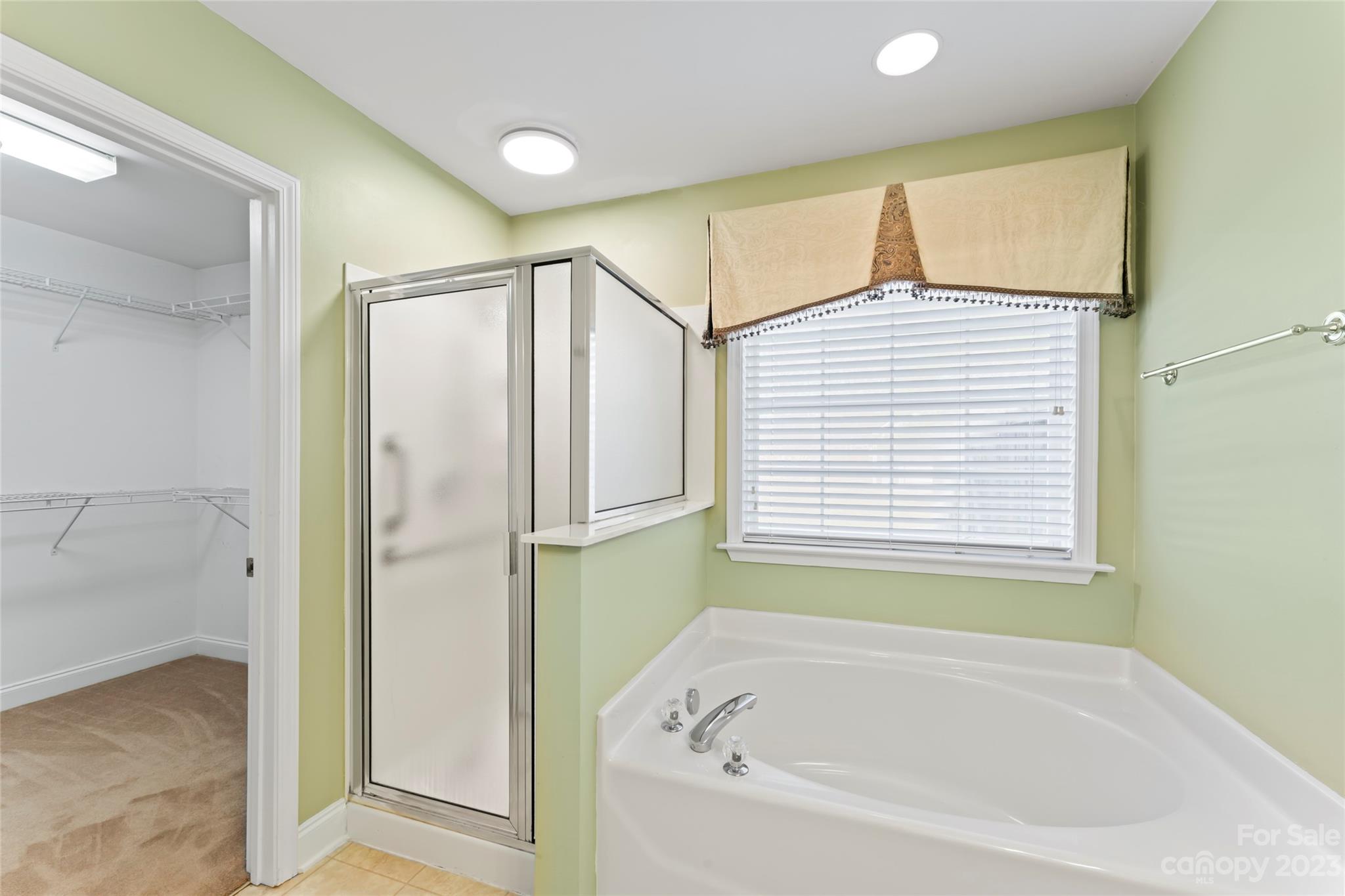 3205 McGee Lane Monroe, NC 28110 - Photo 19 of 34 a bathroom with a bathtub and a shower