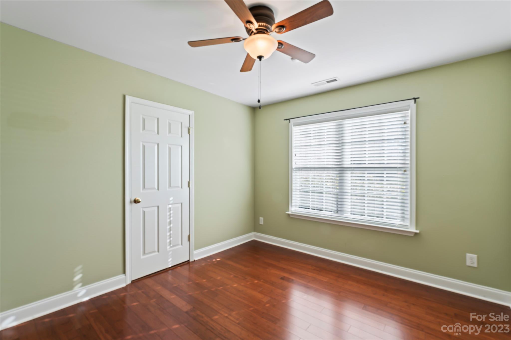 3205 McGee Lane Monroe, NC 28110 - Photo 22 of 34 a view of an empty room with a window and wooden floor