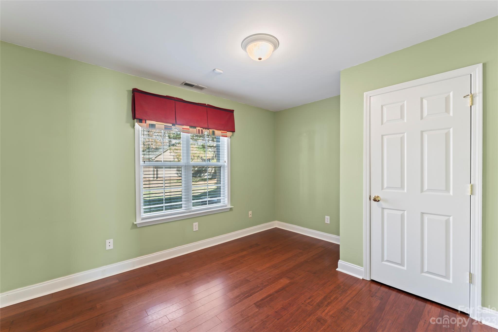 3205 McGee Lane Monroe, NC 28110 - Photo 23 of 34 an empty room with wooden floor and windows
