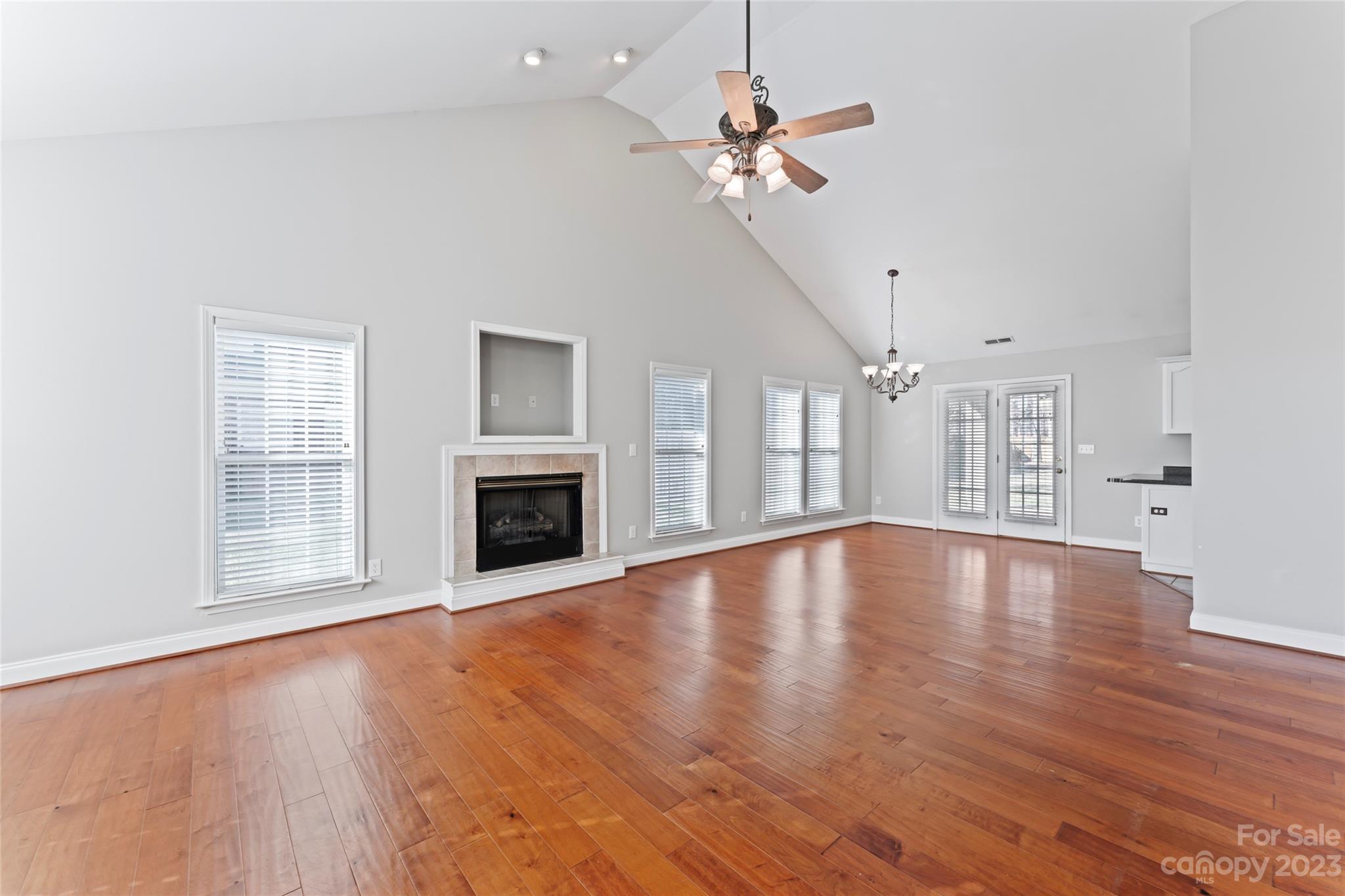 3205 McGee Lane Monroe, NC 28110 - Photo 9 of 34 a view of an empty room with a fireplace and wooden floor