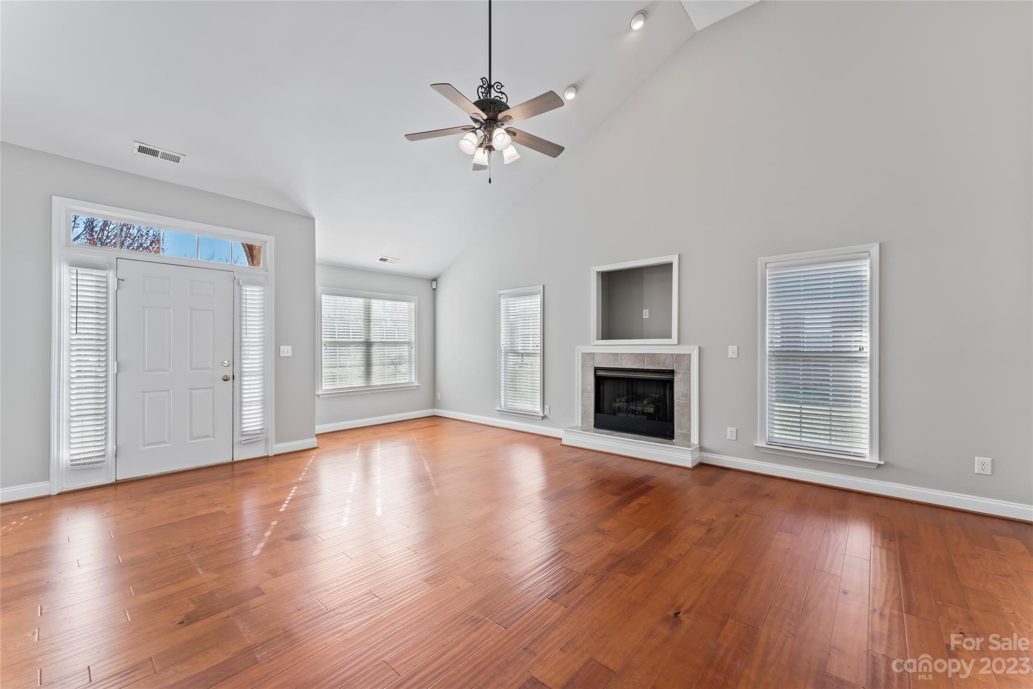 3205 McGee Lane Monroe, NC 28110 - Photo 10 of 34 a view of an empty room with wooden floor fireplace and a window
