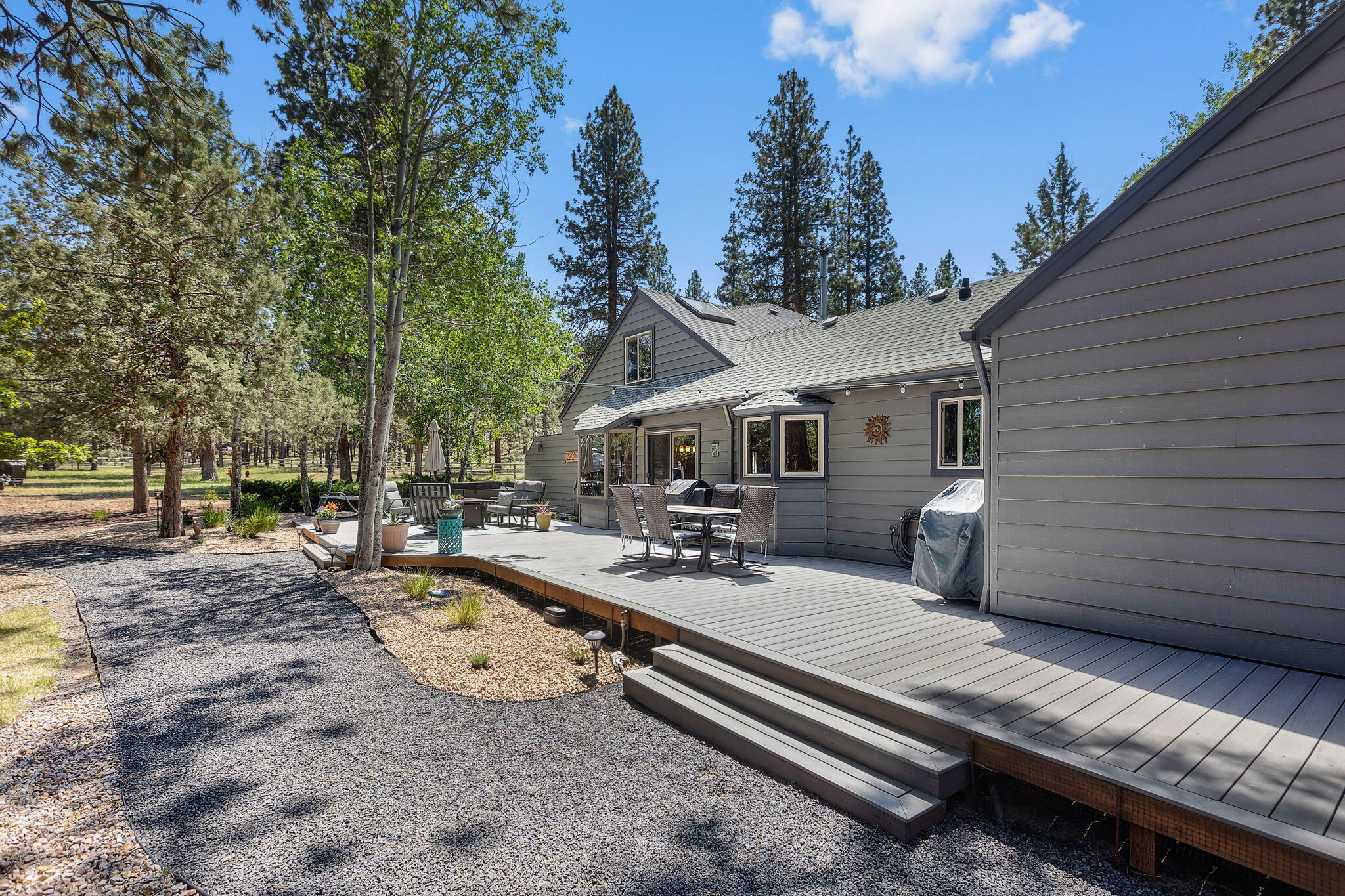 60210 East Ridgeview Drive Bend, OR 97702 - Photo 27 of 55 a view of a patio with chairs and a table