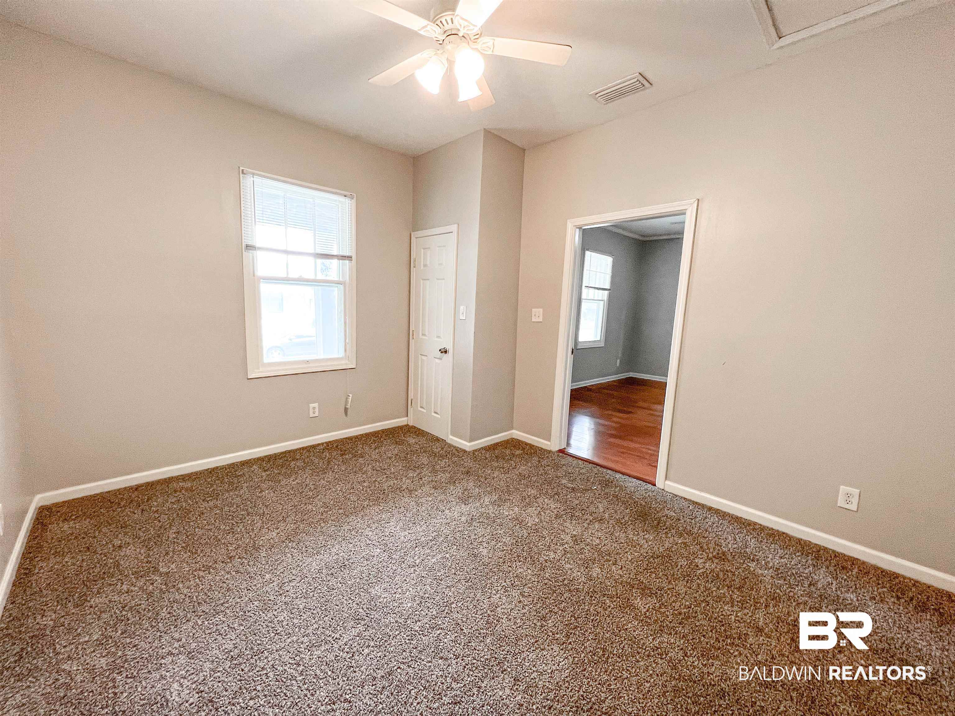 1164 Seneca Street Mobile, AL 36605 - Photo 18 of 22 Unfurnished room featuring a ceiling fan, carpet flooring, visible vents, and baseboards