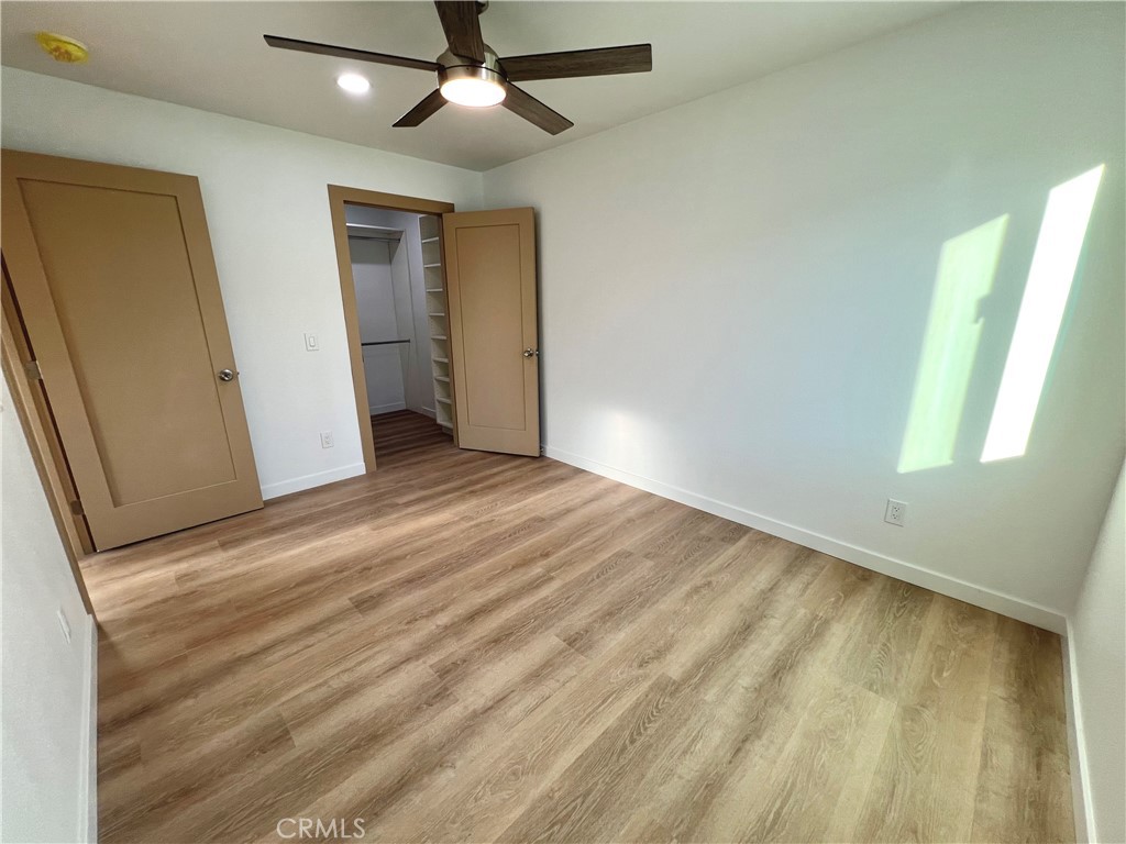 1133 Geraldine Avenue East, Unit B Lancaster, CA 93535 - Photo 11 of 27 wooden floor in an empty room with a window