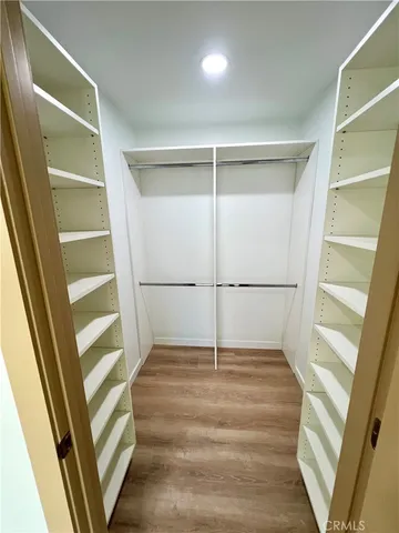 a view of walk in closet with empty racks