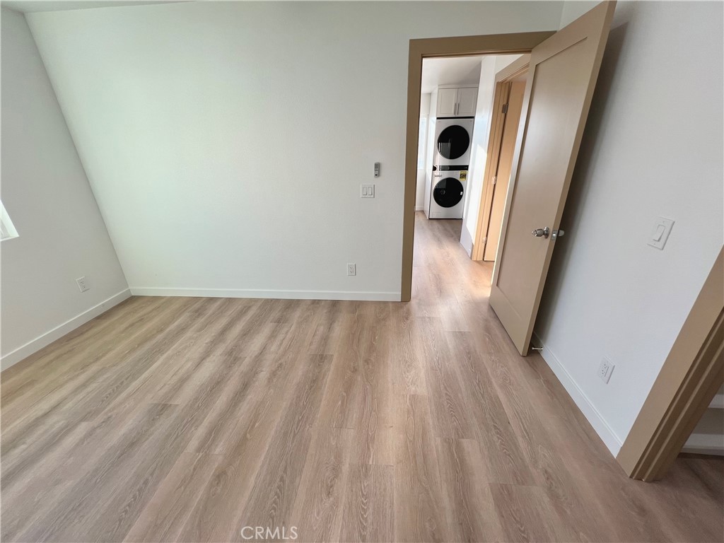 1133 Geraldine Avenue East, Unit B Lancaster, CA 93535 - Photo 16 of 27 a view of a hallway with wooden floor and entryway