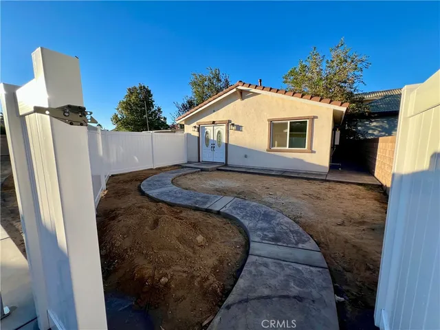 a view of a house with a tub and a yard