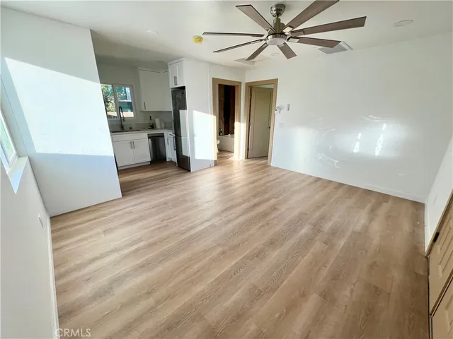 a view of a living room with a white cabinets and wooden floor