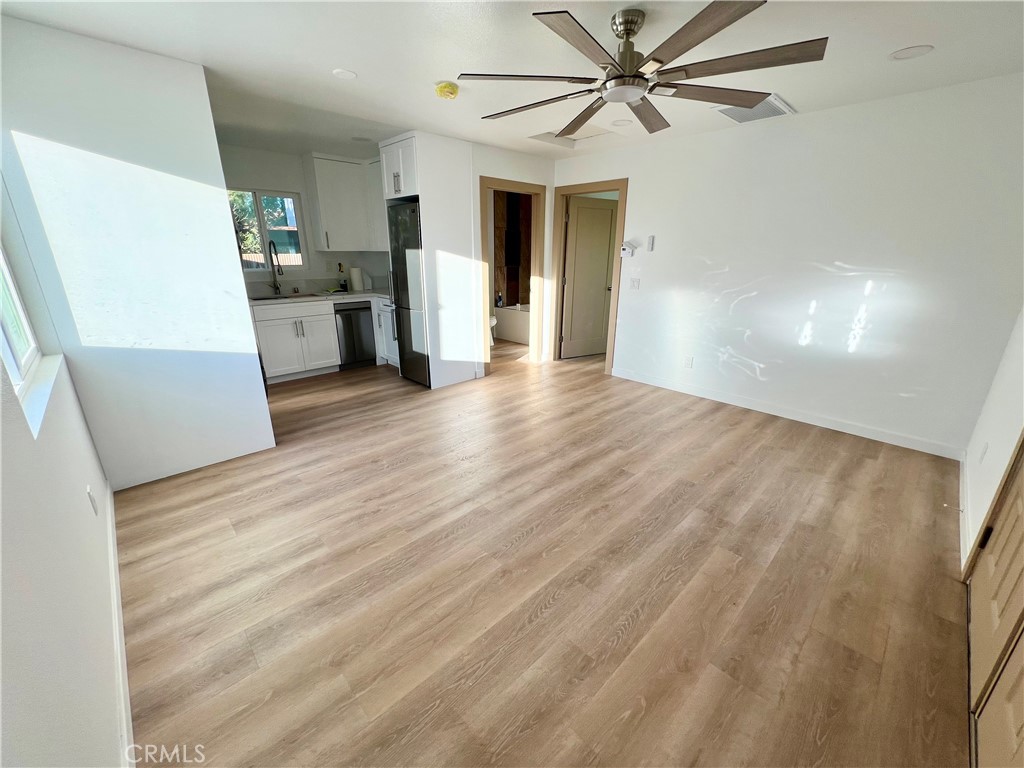 1133 Geraldine Avenue East, Unit B Lancaster, CA 93535 - Photo 4 of 27 a view of a living room with a white cabinets and wooden floor