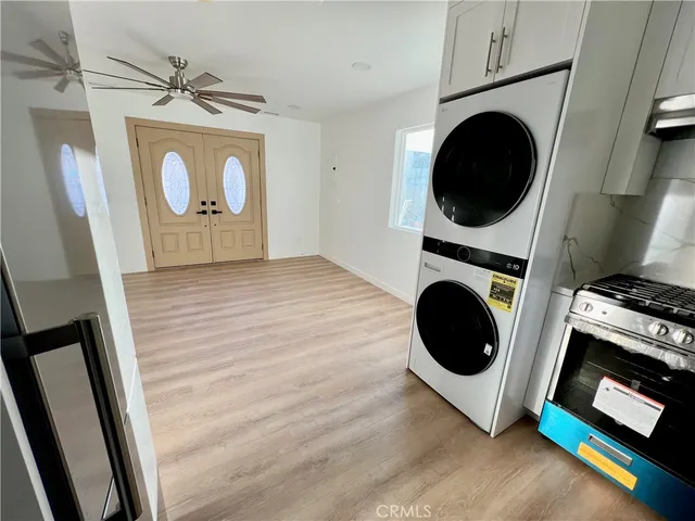 a view of a storage and utility room with washer and dryer