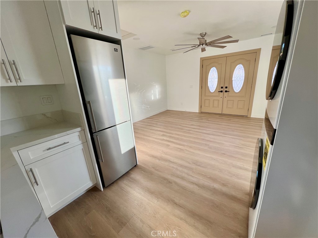 1133 Geraldine Avenue East, Unit B Lancaster, CA 93535 - Photo 7 of 27 a view of a hallway with wooden floor and staircase