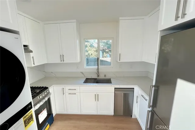 a kitchen with white cabinets and white appliances