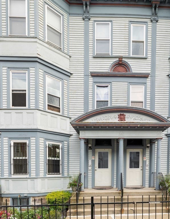 a view of a brick house with large windows