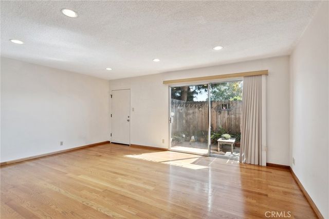 a view of an empty room with glass door