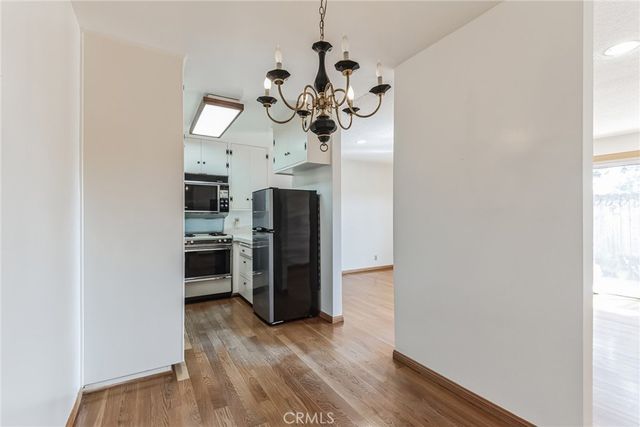 a view of a kitchen with a microwave and a window