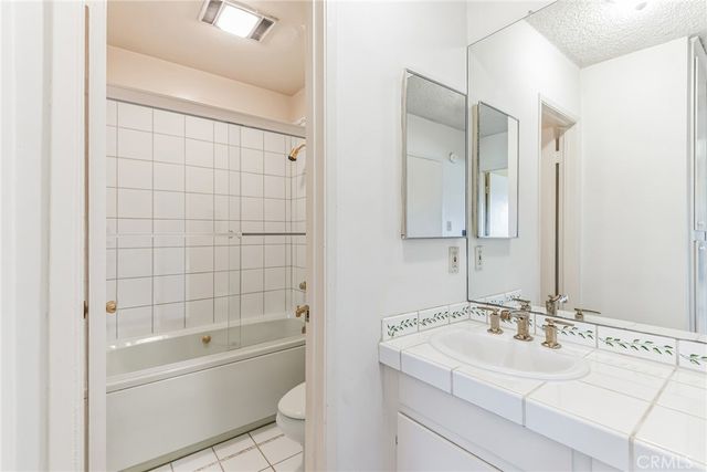 a bathroom with a bathtub a sink a toilet and a mirror