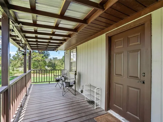 a view of a balcony with wooden floor