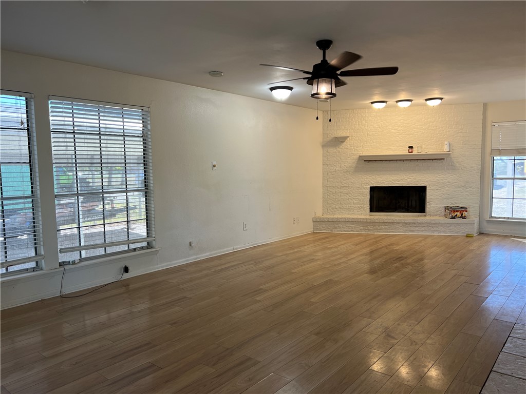 24748 County Road 350 Mathis, TX 78368 - Photo 2 of 16 an empty room with fireplace fan and windows