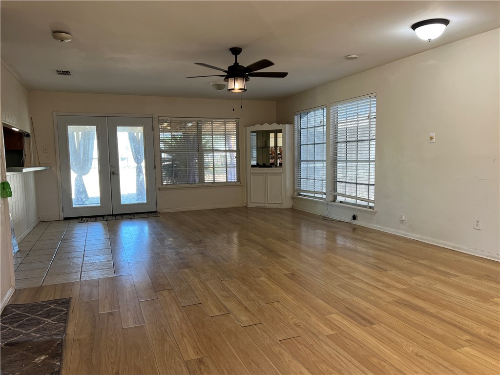 24748 County Road 350 Mathis, TX 78368 - Photo 3 of 16 a view of an empty room with a window and wooden floor