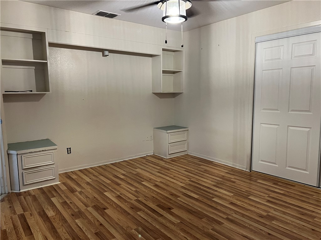 24748 County Road 350 Mathis, TX 78368 - Photo 5 of 16 a view of a room with wooden floor and cabinet