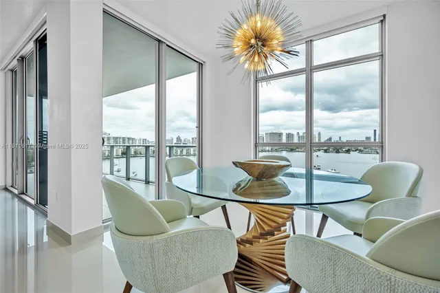 a living room with furniture a rug and a floor to ceiling window
