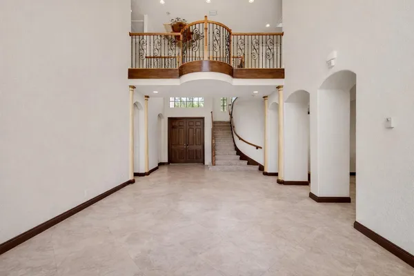 a kitchen with stainless steel appliances granite countertop a stove top oven a sink and a refrigerator