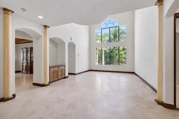 a kitchen with stainless steel appliances granite countertop a stove top oven a sink dishwasher a refrigerator and cabinets with wooden floor