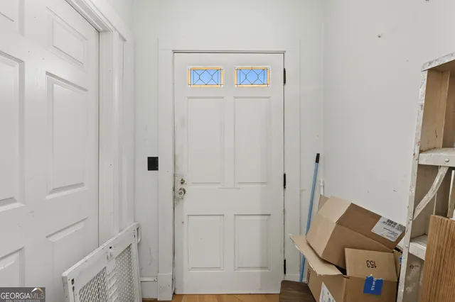 a view of an entryway with wooden floor
