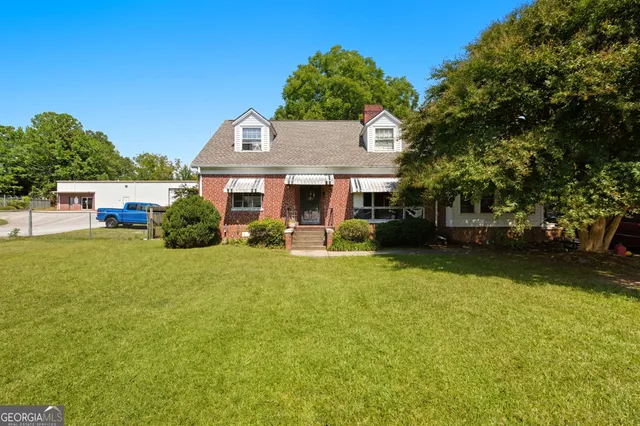 a front view of house with outdoor space and garden