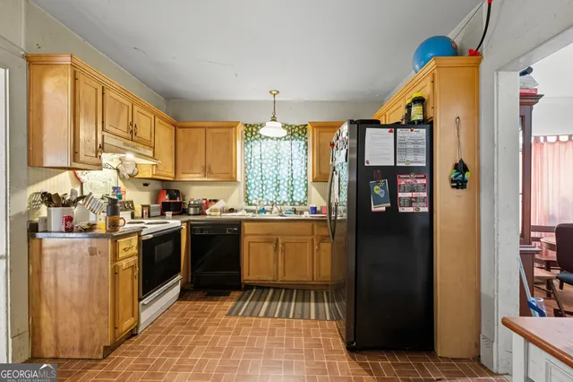 a kitchen with stainless steel appliances granite countertop a refrigerator and a sink