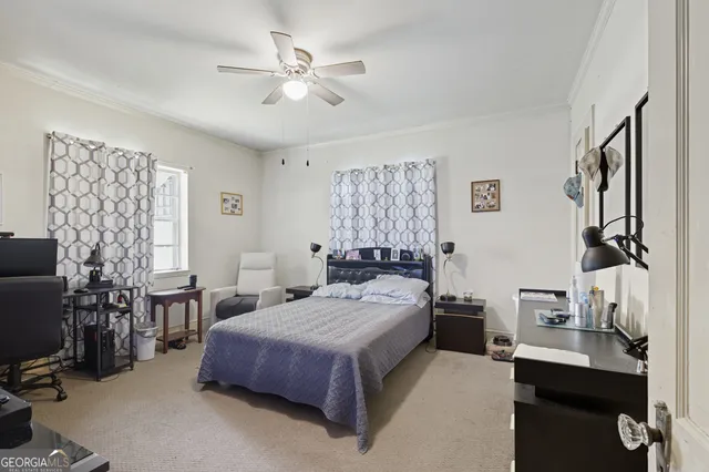 a bedroom with a bed couch and a window