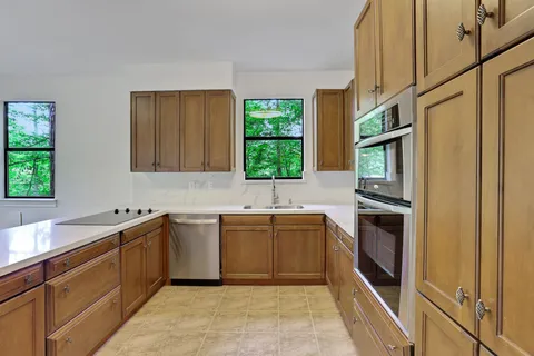 a kitchen with a sink stove and cabinets