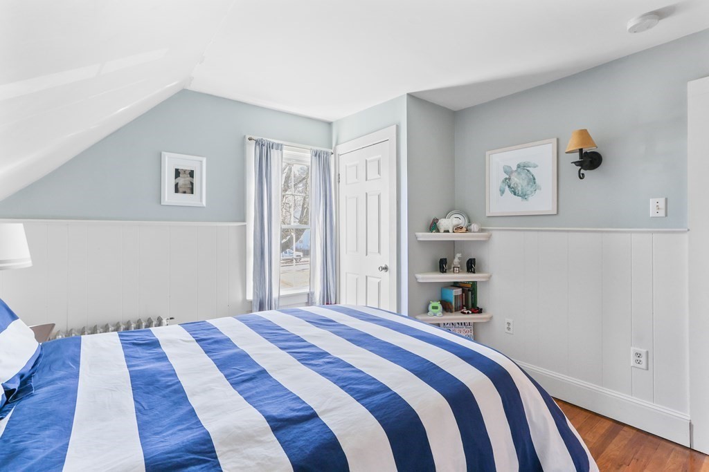 79 Kendall Lane Natick, MA 01760 - Photo 23 of 32 a bedroom with a bed and painting on the wall