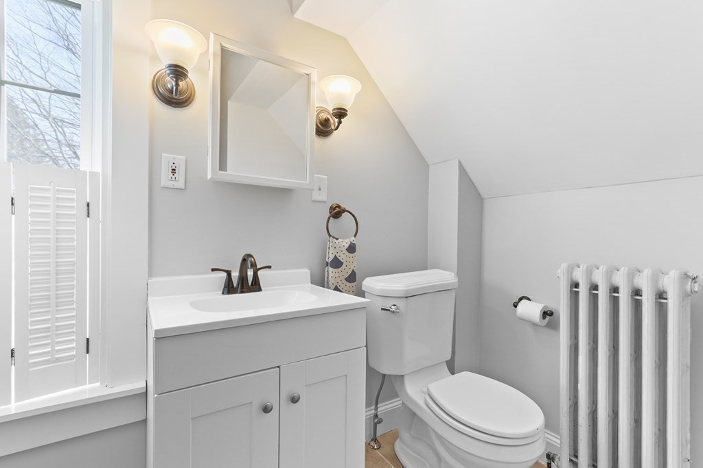 79 Kendall Lane Natick, MA 01760 - Photo 26 of 32 a bathroom with a toilet a sink and mirror