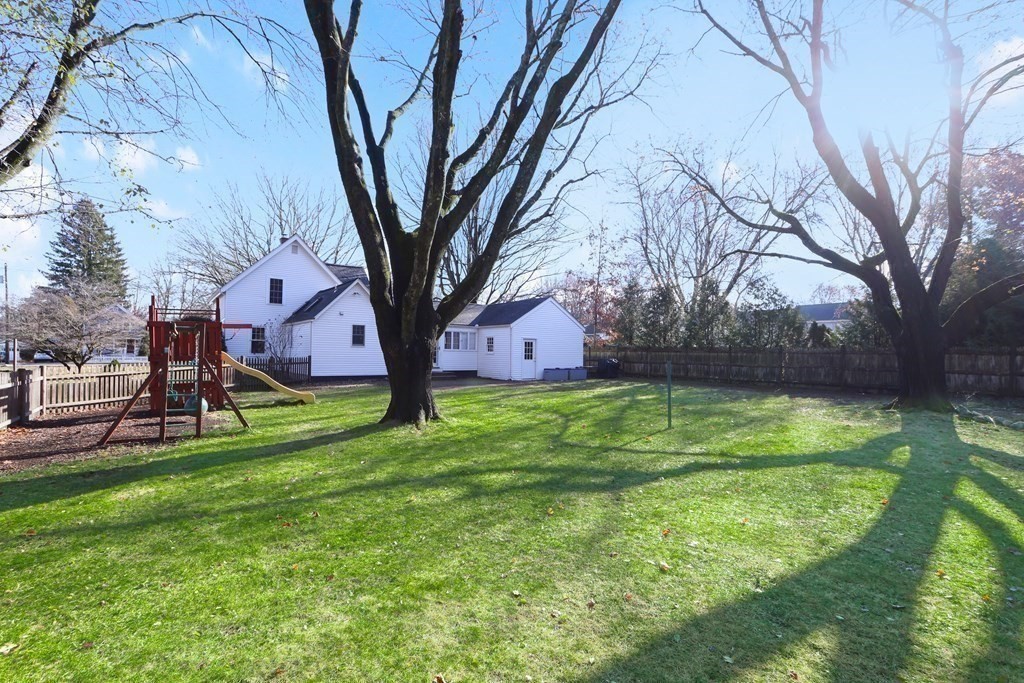 79 Kendall Lane Natick, MA 01760 - Photo 27 of 32 a backyard of a house with lots of green space