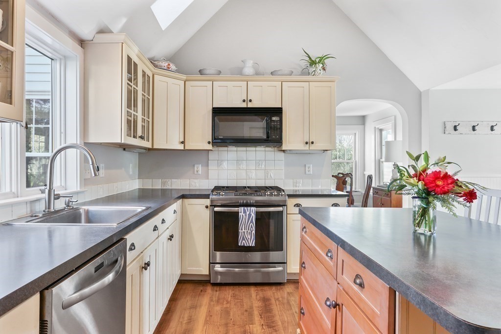 79 Kendall Lane Natick, MA 01760 - Photo 7 of 32 a kitchen with granite countertop a sink stove top oven and microwave