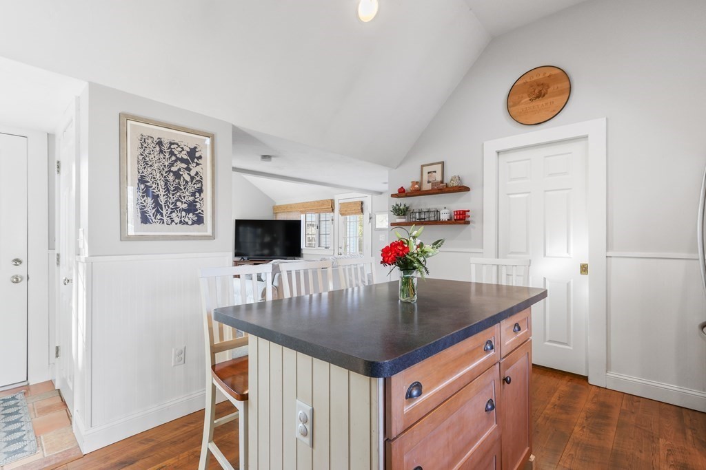 79 Kendall Lane Natick, MA 01760 - Photo 9 of 32 a kitchen with kitchen island granite countertop a sink and a refrigerator with wooden floor