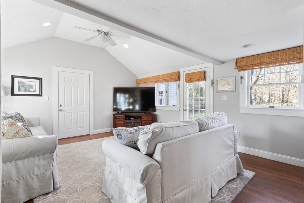 79 Kendall Lane Natick, MA 01760 - Photo 10 of 32 a living room with furniture a large window and a flat screen tv