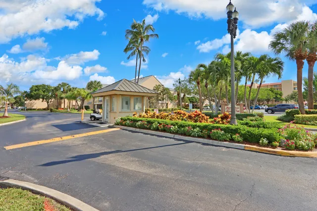 a front view of a house with a yard and potted plants